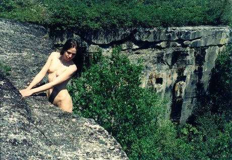 Thin teen Ronin poses nude in the sand and water at the beach