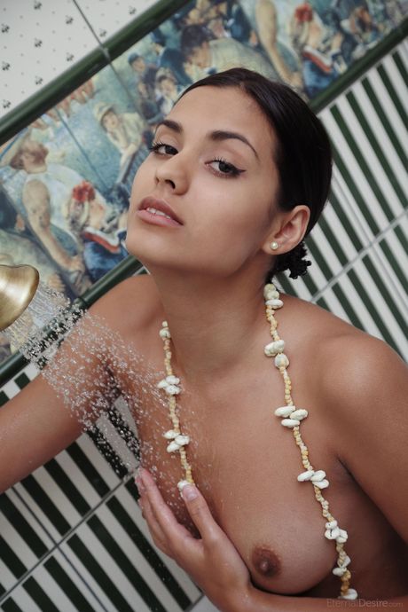 Latina teen Belinda A washes her naked body in a bathtub