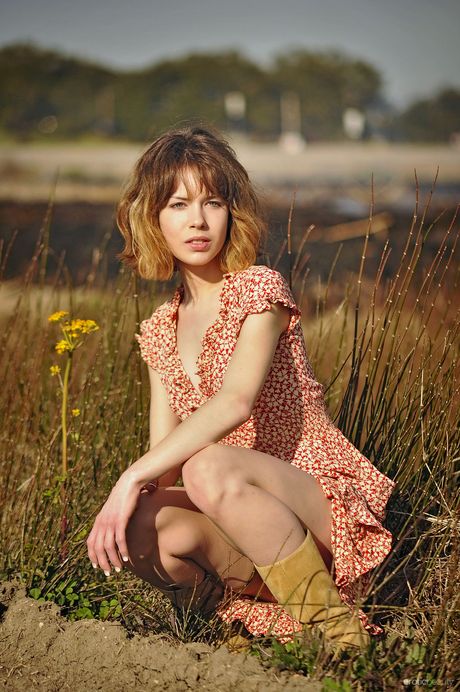 Emily Windsor presents her slim body and bush as she poses in the garden