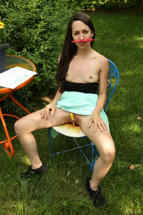 Petite teen Freya Von Doom pisses on the patio before toying her pussy