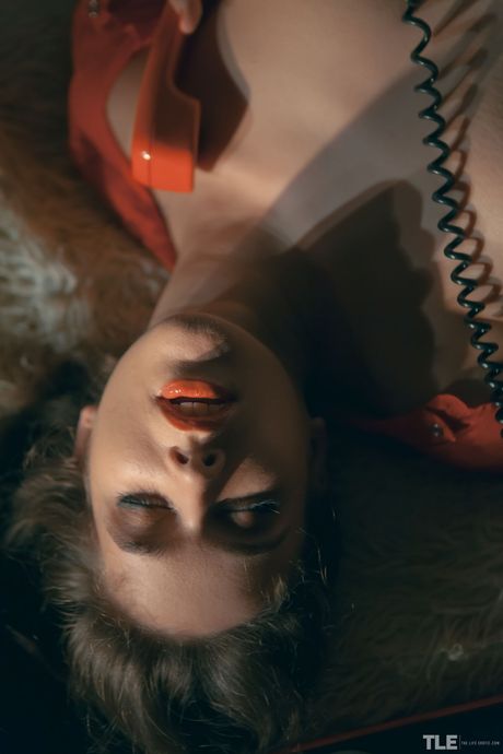 Emily J is in a state of sexual arousal as she masturbates on the bed