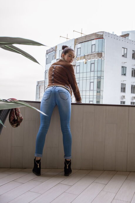 Cute teen Solange removes her lingerie and poses nude in the kitchen