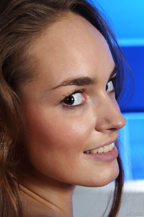 Slender teen Milana F presents her big tits and bald pussy in the nude