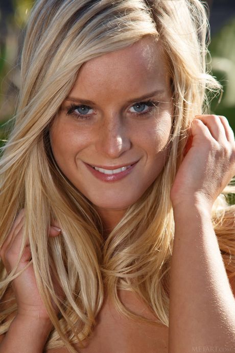 Blonde babe Miela A revealing tiny teen tits and bald cunt outdoors