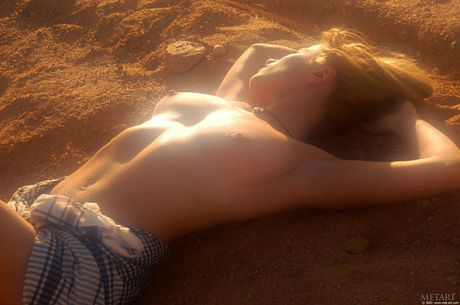 Blonde teen Natasha C gets naked on a beach without shyness