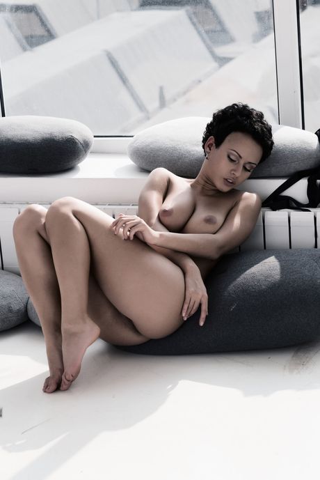 Russian girl Pammie Lee removes a black dress to pose nude in heels