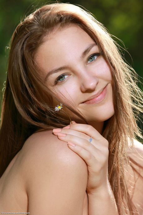 Lean teen Izabel A shows her small tits and shaved pussy in the countryside