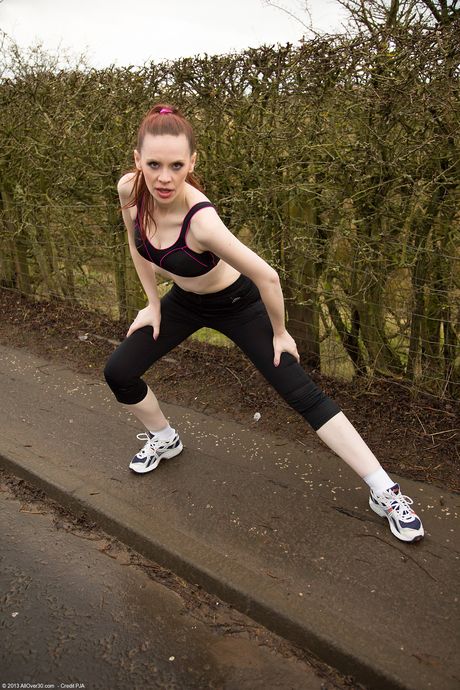 Hot MILF Mystique strips and shows her bush while doing yoga outdoors