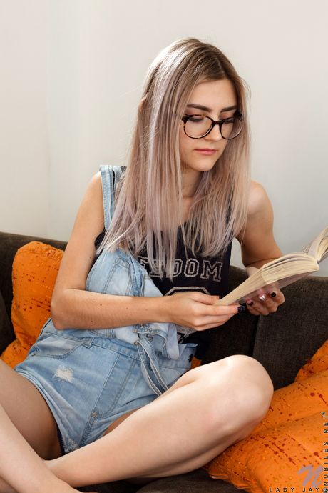 Sexy blonde Lady Jay strips and masturbates while reading in her glasses