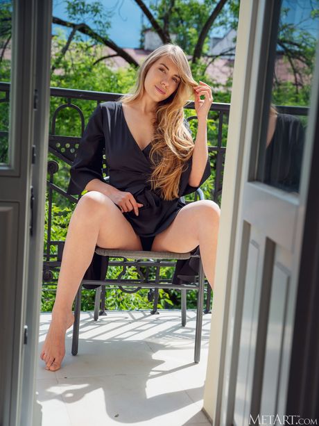 Lovely teen Ryana goes nude on a balcony confidently