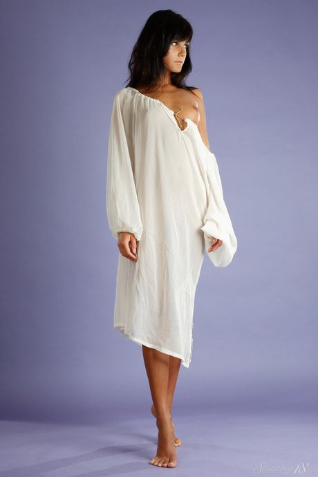 Slender teen Gloria B slips off her lingerie to model naked in a garden