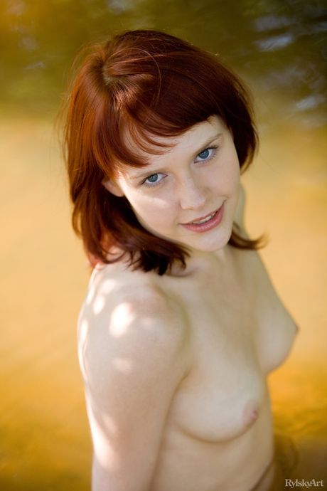 Sexy redhead Anelie shows her tiny tits and poses naked in a solo