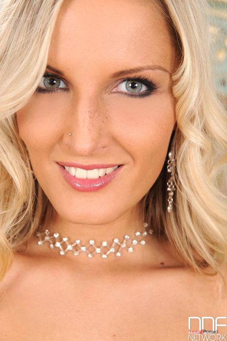 Porn World: Blonde Neilla Feline strips and toys her trimmed pussy on a table