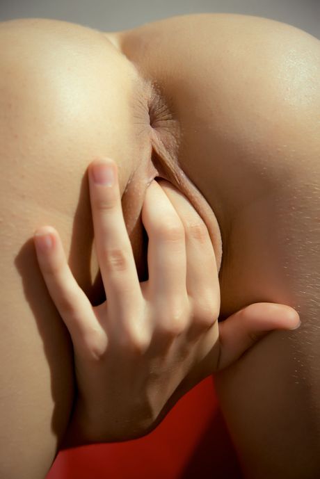 Brunette teen Angela F fingers her pussy while completely naked