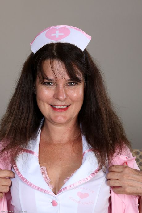 Mature nurse Sherry Lee shows her big ass and spreads her hairy pussy
