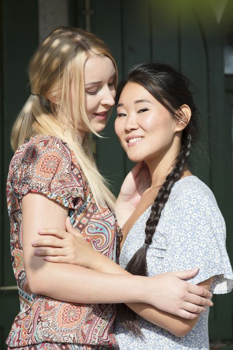 Teen lesbians Katana & Amaris remove their bikinis before licking pussies on a patio