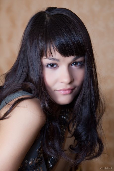 Petite teen Shereen A highlights her landing strip pussy while naked on a bed