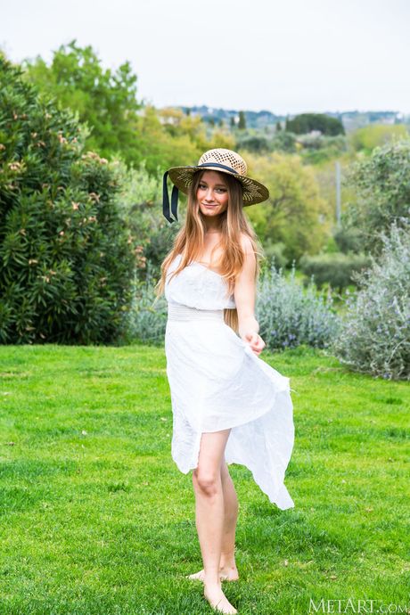 Blonde teen Isla gets completely naked on a garden chair in a field