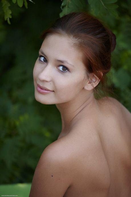 Teen solo girl Afrodita gets naked on a sandy beach in a bikini