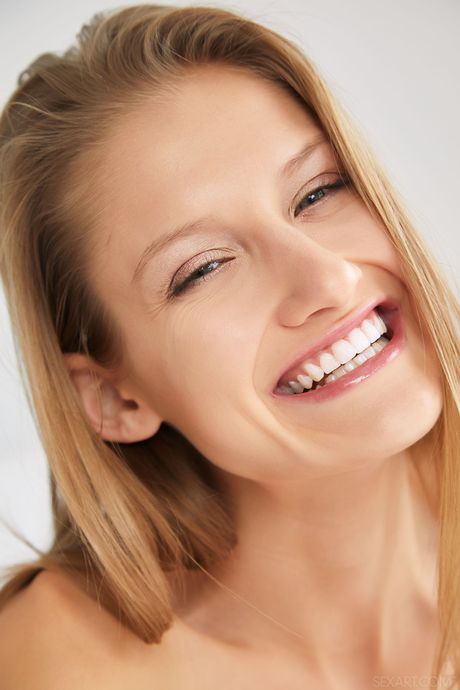 Slender teen Tiffany Tatum fingers her pussy after getting naked on a bed