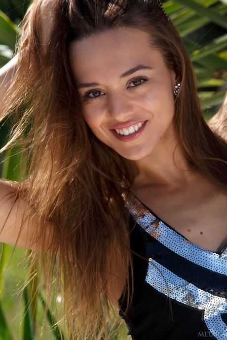 Slender teen Dominika A models totally naked on a rocky outcropping