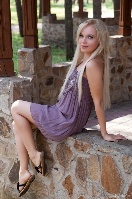 Blonde teen Feeona gets naked on a rocky outcropping in sandals