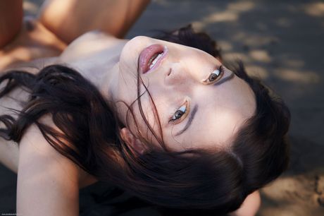 Precious teen Anastasia poses totally naked on a sandy beach