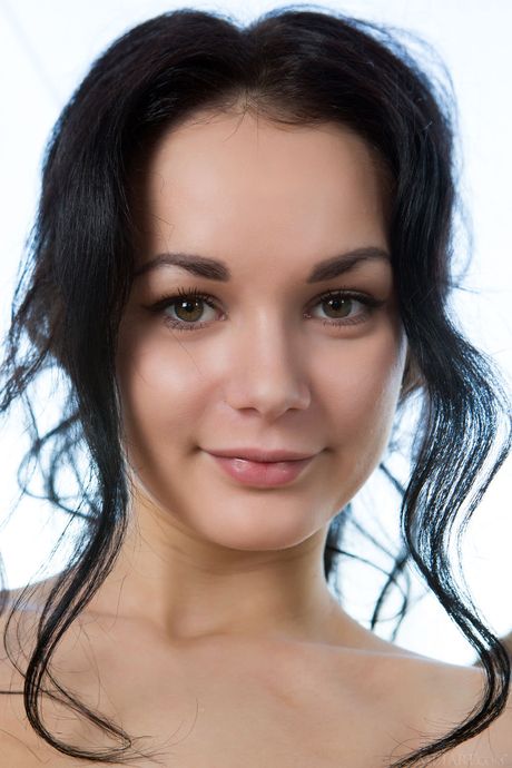 Brunette teen Josephine removes her stockings to get totally naked