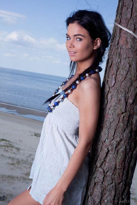 Endearing teen Lachia A models totally naked on a hammock at the beach
