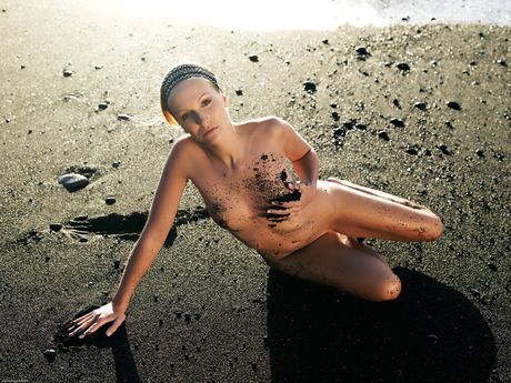Delicate teen Estee poses completely naked on a sandy beach