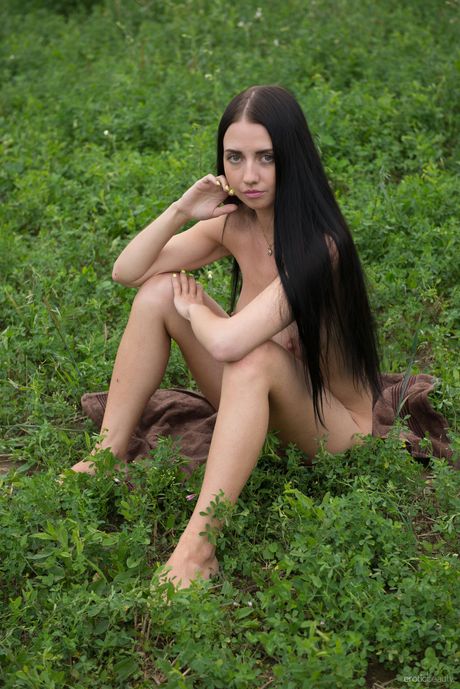 Solo girl Veronica Snezna gets naked in a field of wildflowers