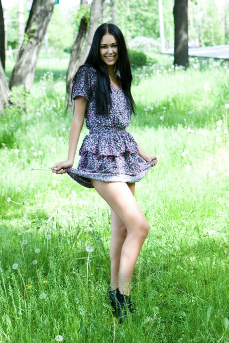 Engaging teen Macy B strips her dress & poses nude in the backyard