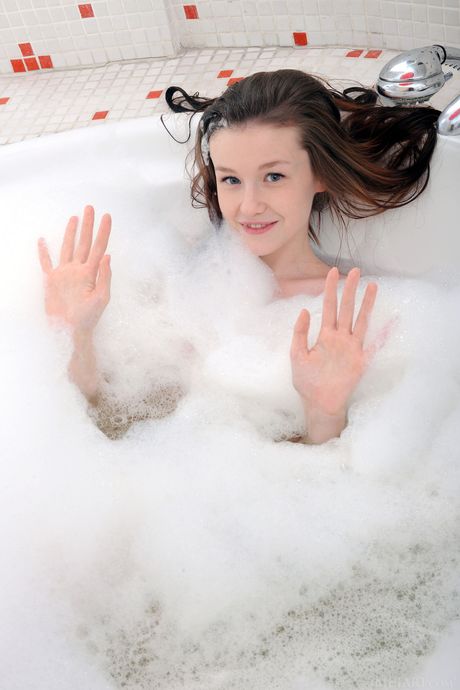 Ukrainian erotic model Emily Bloom gets naked and wet in a bathtub
