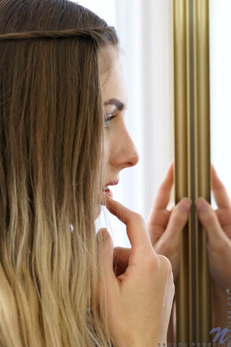 Blonde babe Sandra Phoenix unveils her big tits and rubs her pussy in a solo