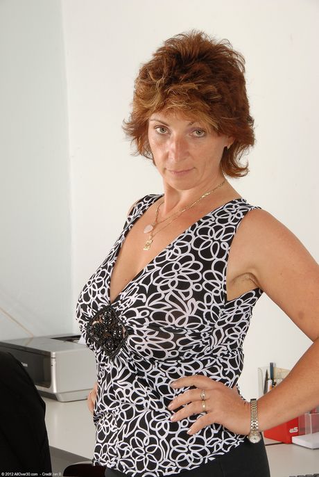 Mature secretary Misti shows her big natural tits and hairy vagina