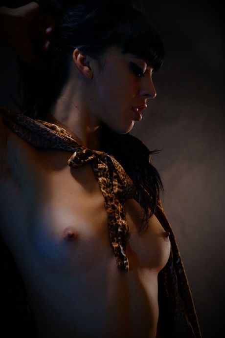 Naked teen Natalia masturbates with a dildo while smoking a cigarette