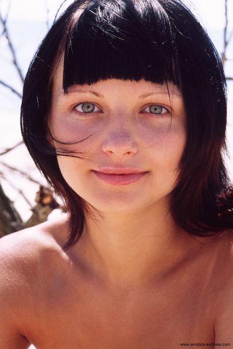 Charming teen Valjana models totally naked on a blanket in the backyard