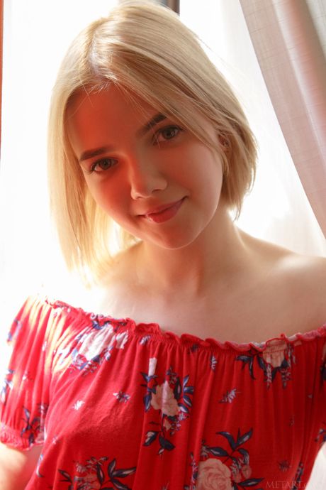 Endearing teen Chanel Fenn removes a red bikini to pose nude in a courtyard