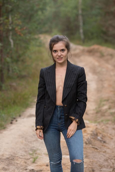 Svelte teen Pola strips naked in the bush & shows her small tits & bald pussy