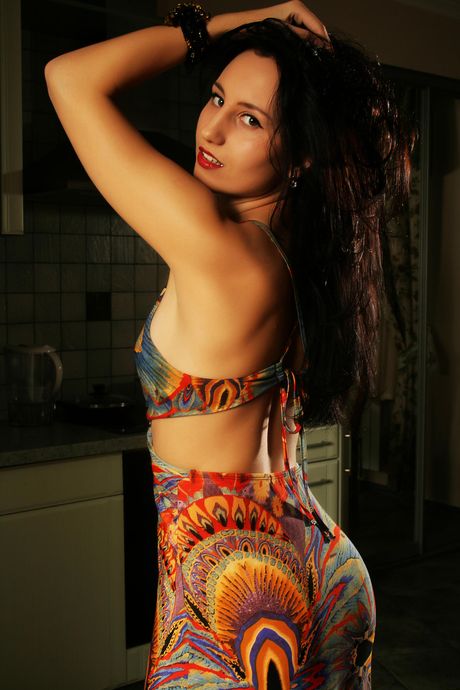 Slender teen Kitty M gets naked in heels before fingering her pussy