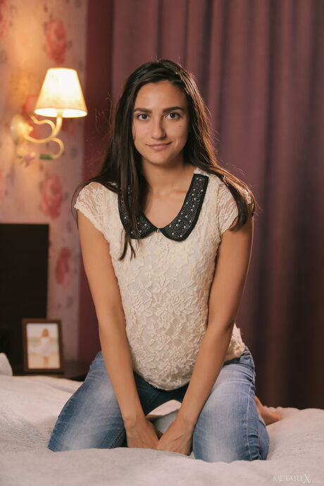 Lovely teen Cira Nerri fingers her pussy after getting naked on her bed