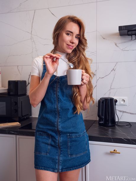 Ukrainian beautiful Ryana gets naked and displays her big tits and pussy on a kitchen counter