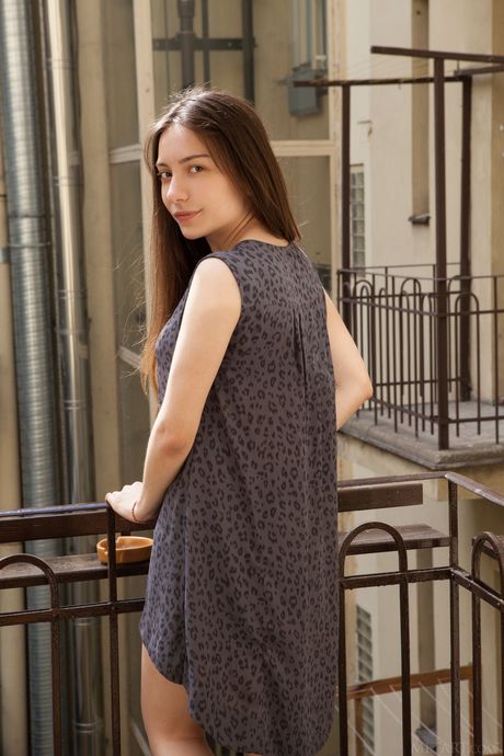 Brunette babe Maxima strips off her clothes and presents her hairy pussy