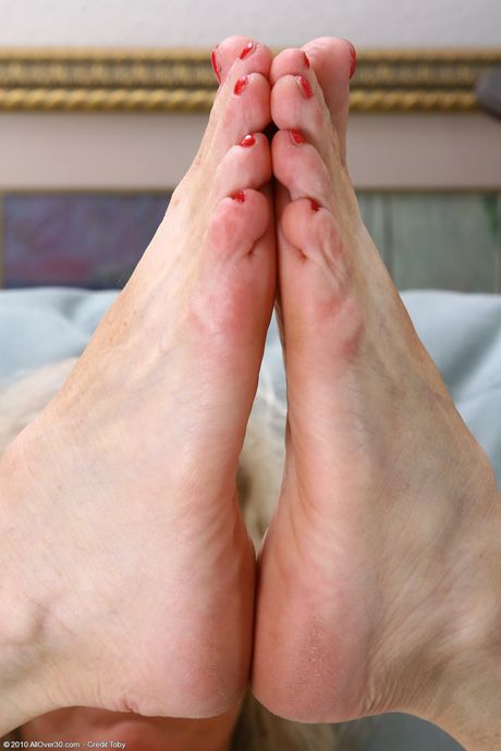 Blonde granny Michelle V shows her trimmed pussy in red lingerie