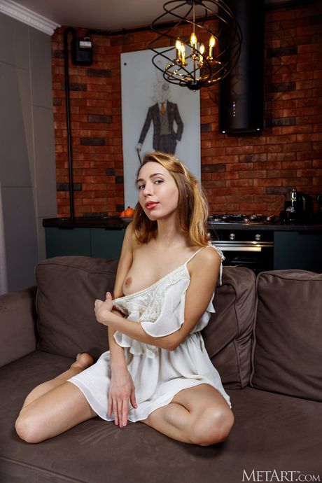 Pure teen Madelina goes naked in a pair of boots on a patio