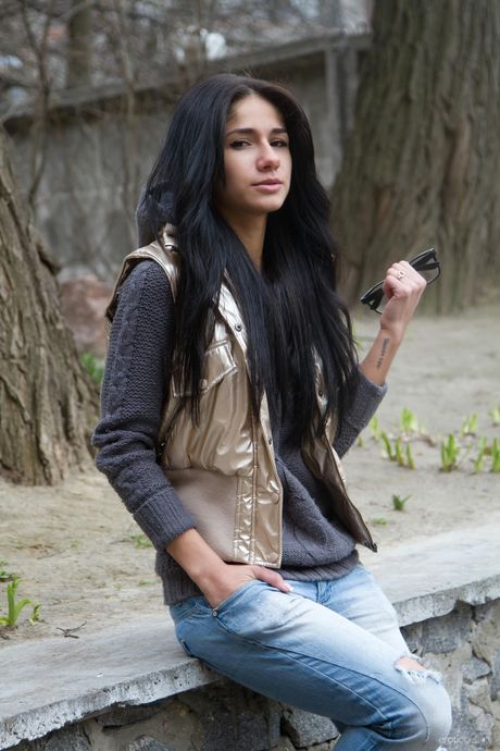 Young beauty Malina A takes off everything on a sidewalk in a public place