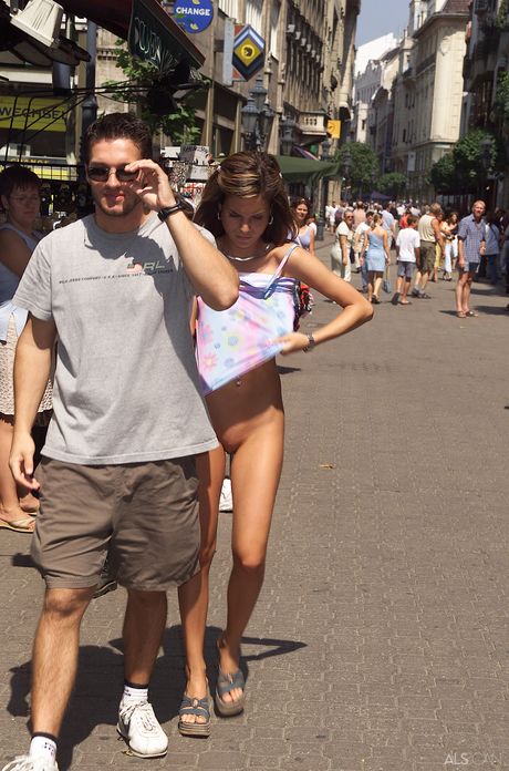 Slender teen Nella strips naked in public and shows her tiny tits & ass