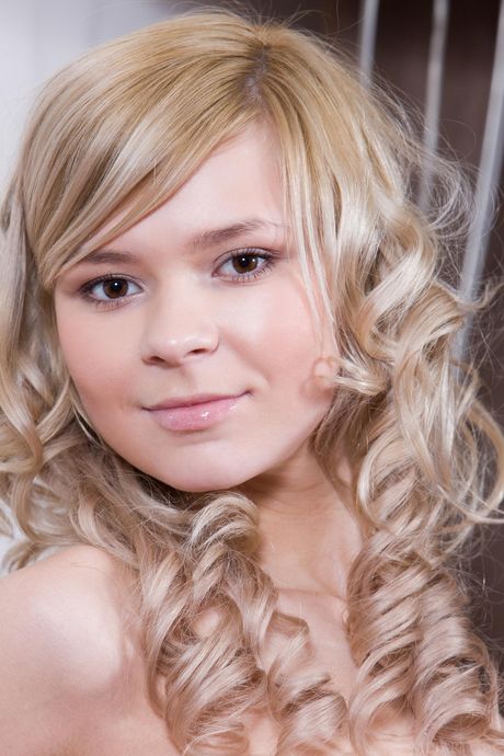 Alluring teen Paloma B removes her stockings to pose nude