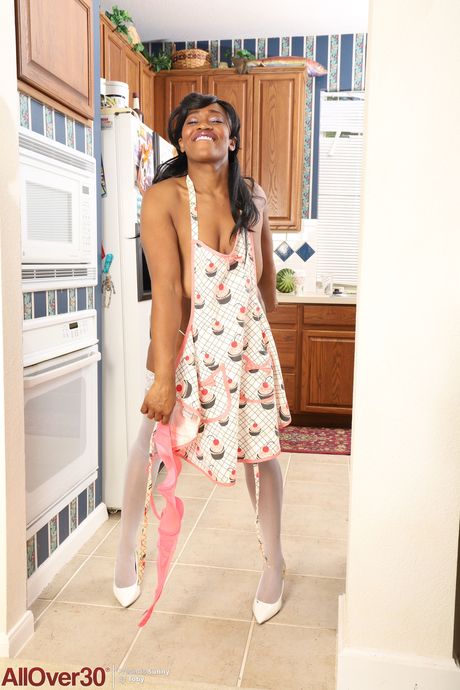 Black MILF Sunny shows off her big ass & her big tits while doing housework