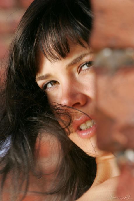 Lean teen Anais gets naked in a backyard before showing her bald pussy